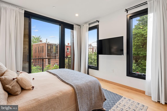 135 13th St NE, Washington, DC 20002 - bedroom with wood finished floors, multiple windows, baseboards, and recessed lighting