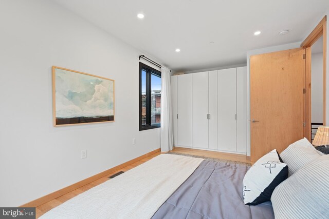 135 13th St NE, Washington, DC 20002 - bedroom with light wood-type flooring, recessed lighting, and baseboards