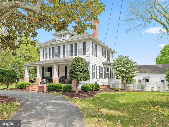 417 S Main St, Berlin, MD 21811 - american foursquare style home featuring a porch, a chimney, and a shingled roof