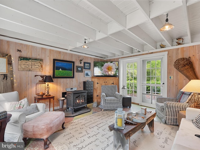 417 S Main St, Berlin, MD 21811 - living area with wood walls, a wood stove, and beam ceiling