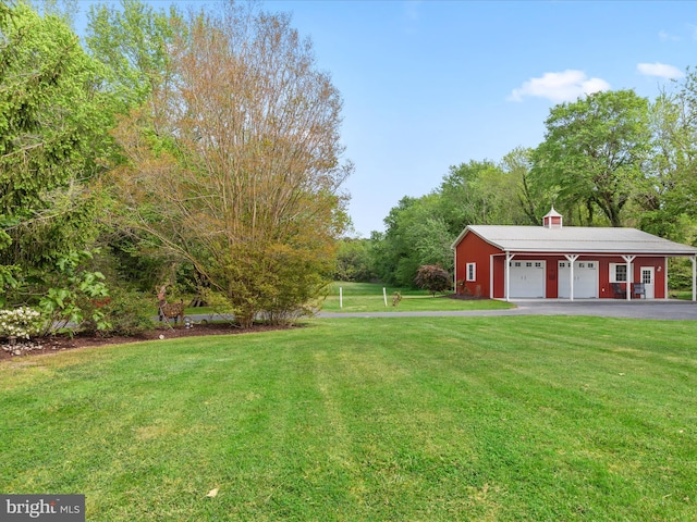 417 S Main St, Berlin, MD 21811 - view of green lawn featuring a detached garage and an outdoor structure