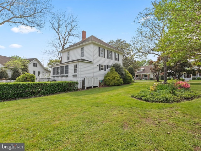 417 S Main St, Berlin, MD 21811 - view of home's exterior with a chimney and a lawn