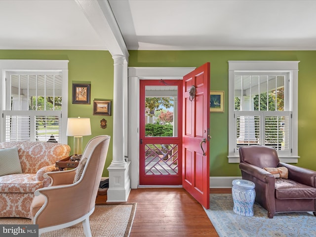417 S Main St, Berlin, MD 21811 - foyer entrance featuring decorative columns, healthy amount of natural light, ornamental molding, wood finished floors, and baseboards