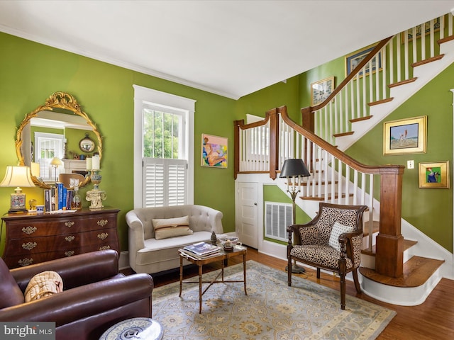 417 S Main St, Berlin, MD 21811 - living room with stairway, wood finished floors, crown molding, and baseboards