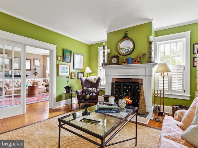 417 S Main St, Berlin, MD 21811 - living room with a lit fireplace, crown molding, wood finished floors, and baseboards