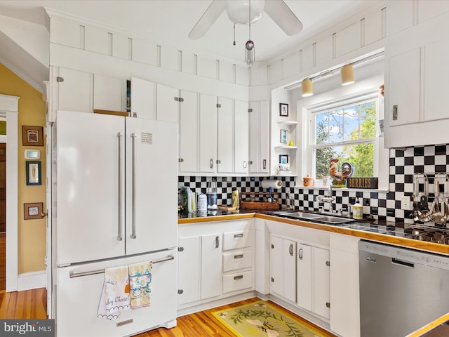 417 S Main St, Berlin, MD 21811 - kitchen with freestanding refrigerator, dishwasher, a sink, white cabinets, and crown molding