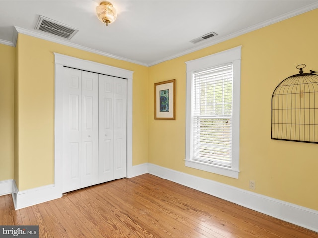 417 S Main St, Berlin, MD 21811 - unfurnished bedroom featuring crown molding, wood finished floors, baseboards, and a closet