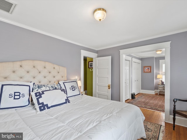 417 S Main St, Berlin, MD 21811 - bedroom with ornamental molding, wood finished floors, and baseboards