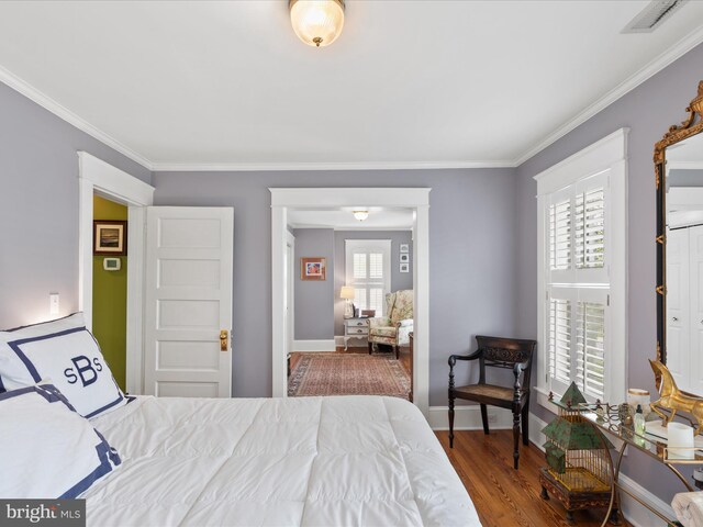 417 S Main St, Berlin, MD 21811 - bedroom featuring wood finished floors, ornamental molding, and baseboards