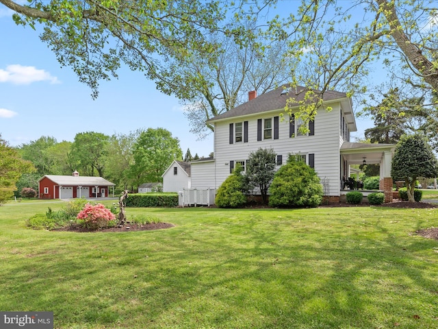 417 S Main St, Berlin, MD 21811 - view of grassy yard featuring a detached garage