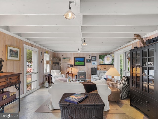 417 S Main St, Berlin, MD 21811 - living room with a wood stove, wooden walls, and finished concrete flooring