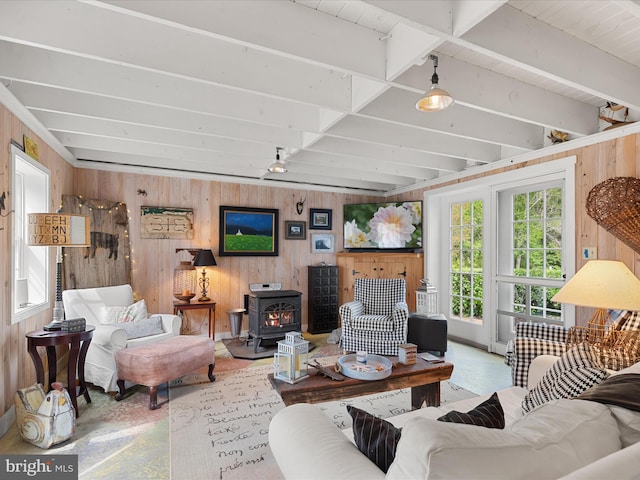 417 S Main St, Berlin, MD 21811 - living room with a wood stove, wooden walls, and beamed ceiling
