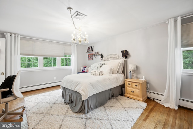 276 Cherry Ln, Doylestown, PA 18901 - bedroom with baseboard heating, wood finished floors, and a chandelier