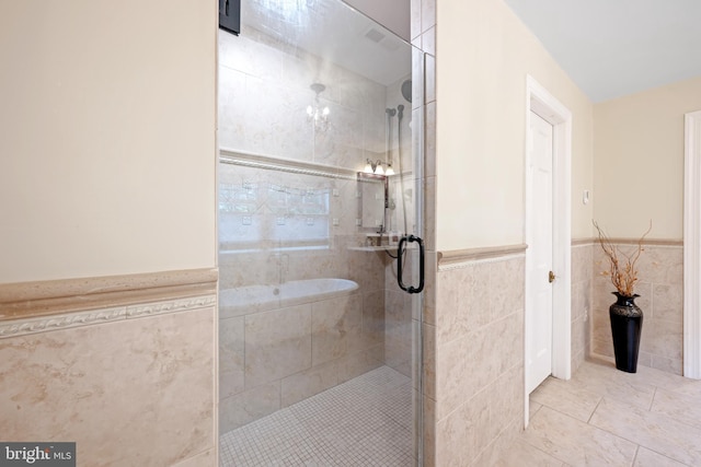 276 Cherry Ln, Doylestown, PA 18901 - bathroom featuring a shower stall, a wainscoted wall, tile walls, and tile patterned flooring