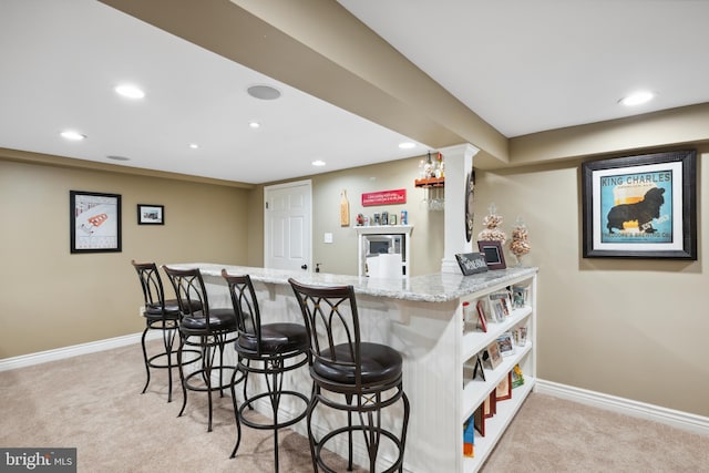 276 Cherry Ln, Doylestown, PA 18901 - kitchen with light colored carpet, a breakfast bar area, recessed lighting, baseboards, and light stone countertops