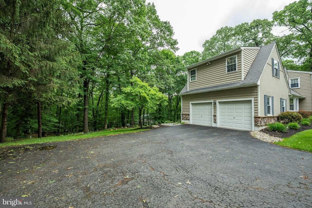 276 Cherry Ln, Doylestown, PA 18901 - view of home's exterior featuring asphalt driveway, an attached garage, and a shingled roof