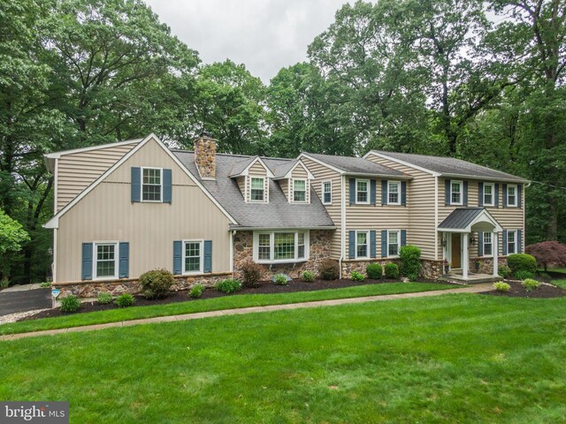 276 Cherry Ln, Doylestown, PA 18901 - view of front of property featuring stone siding, a chimney, a front lawn, and view of wooded area