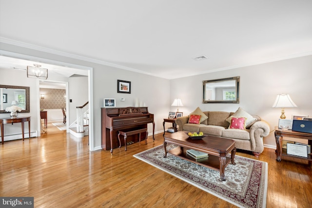 276 Cherry Ln, Doylestown, PA 18901 - living area featuring stairway, a baseboard radiator, ornamental molding, baseboards, and light wood finished floors