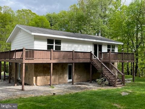 17 Driftwood Ln, Oakland, MD 21550 - rear view of house with a wooden deck, stairs, and a lawn