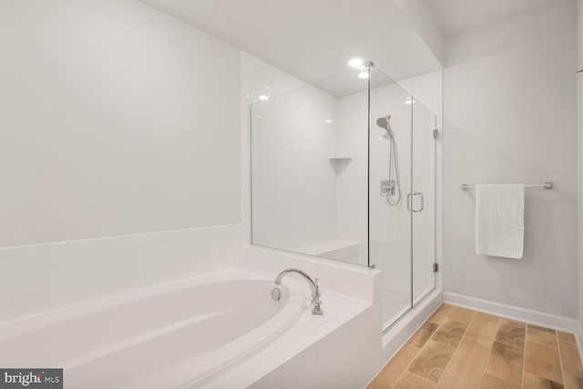 22287 Cornerstone Crossing Ter, Ashburn, VA 20148 - bathroom featuring a bath, a stall shower, and baseboards