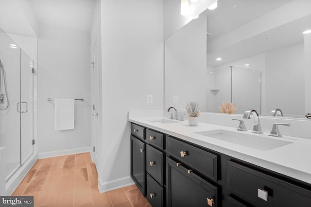 22287 Cornerstone Crossing Ter, Ashburn, VA 20148 - bathroom with double vanity, a shower stall, baseboards, and wood finished floors