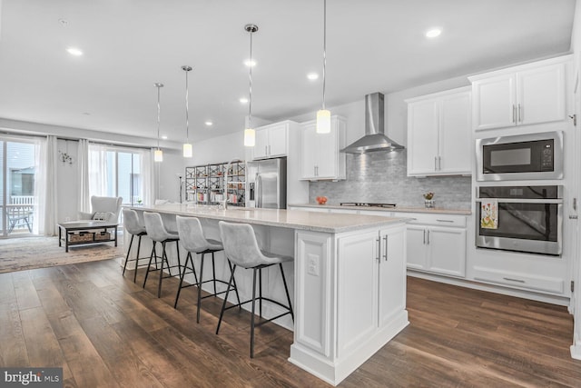 22287 Cornerstone Crossing Ter, Ashburn, VA 20148 - kitchen with stainless steel appliances, wall chimney range hood, dark wood-style floors, white cabinetry, and recessed lighting