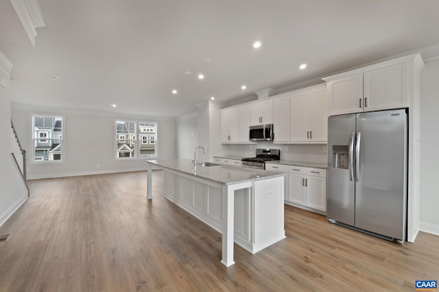 8 Talen Ln, Charlottesville, VA 22911 - kitchen featuring stainless steel appliances, a sink, crown molding, white cabinets, and a kitchen island with sink