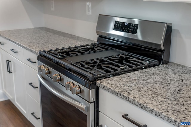 8 Talen Ln, Charlottesville, VA 22911 - kitchen featuring stainless steel range with gas stovetop, light stone countertops, white cabinets, and dark wood-style floors