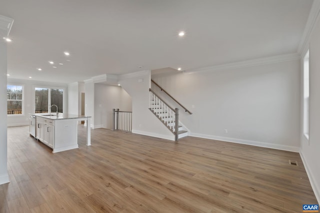 8 Talen Ln, Charlottesville, VA 22911 - unfurnished living room featuring ornamental molding, baseboards, light wood finished floors, a sink, and recessed lighting