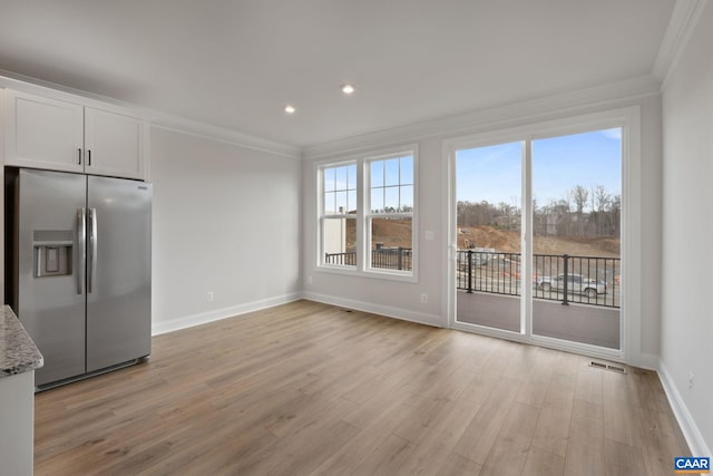 8 Talen Ln, Charlottesville, VA 22911 - kitchen with stainless steel fridge with ice dispenser, crown molding, light wood-type flooring, white cabinets, and light stone counters