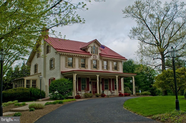 424 Dresher Rd, Horsham, PA 19044 - victorian house with a porch, a front lawn, metal roof, driveway, and stucco siding