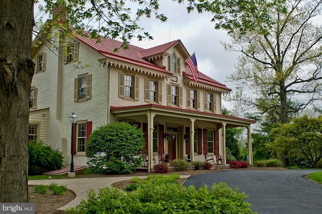 424 Dresher Rd, Horsham, PA 19044 - victorian home with covered porch, stucco siding, a chimney, and metal roof