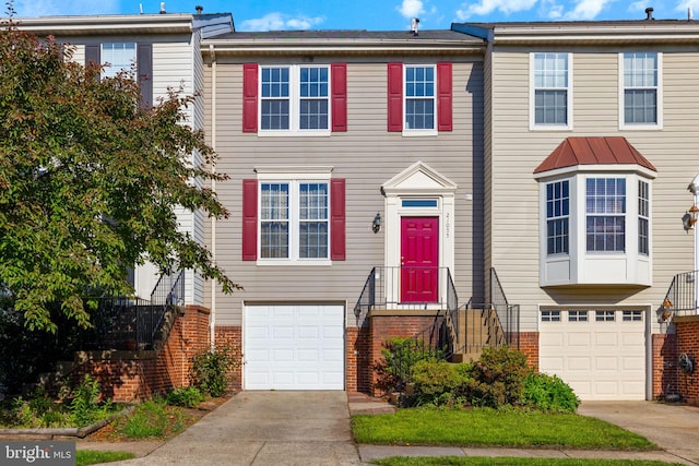 21055 Cornerpost Sq, Ashburn, VA 20147 - townhome / multi-family property with an attached garage, driveway, and brick siding