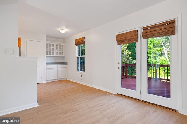 21055 Cornerpost Sq, Ashburn, VA 20147 - unfurnished dining area with light wood-type flooring and baseboards