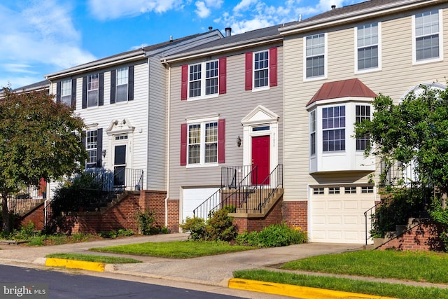 21055 Cornerpost Sq, Ashburn, VA 20147 - townhome / multi-family property featuring a garage, concrete driveway, brick siding, and stairs