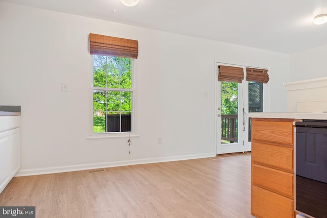 21055 Cornerpost Sq, Ashburn, VA 20147 - kitchen with light wood-type flooring, light countertops, and baseboards