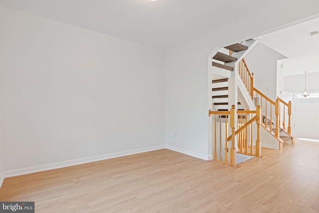 21055 Cornerpost Sq, Ashburn, VA 20147 - unfurnished room with light wood-style flooring, stairway, and baseboards