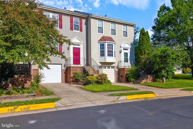 21055 Cornerpost Sq, Ashburn, VA 20147 - townhome / multi-family property with an attached garage, concrete driveway, and brick siding