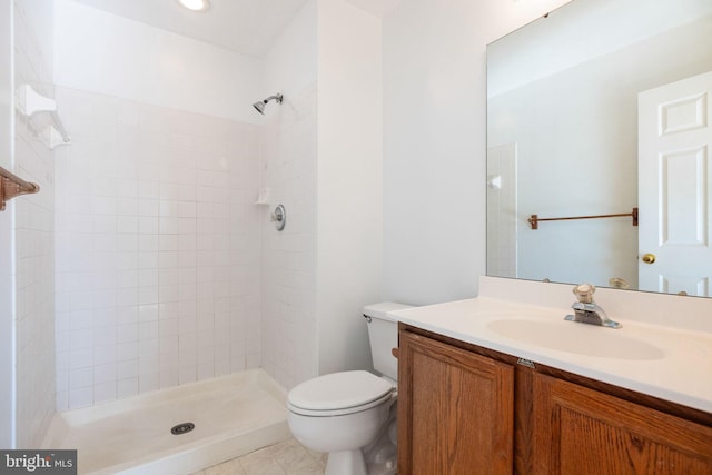 21055 Cornerpost Sq, Ashburn, VA 20147 - bathroom featuring a tile shower, vanity, toilet, and tile patterned floors