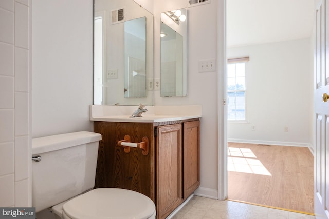 21055 Cornerpost Sq, Ashburn, VA 20147 - bathroom featuring toilet, vanity, and baseboards