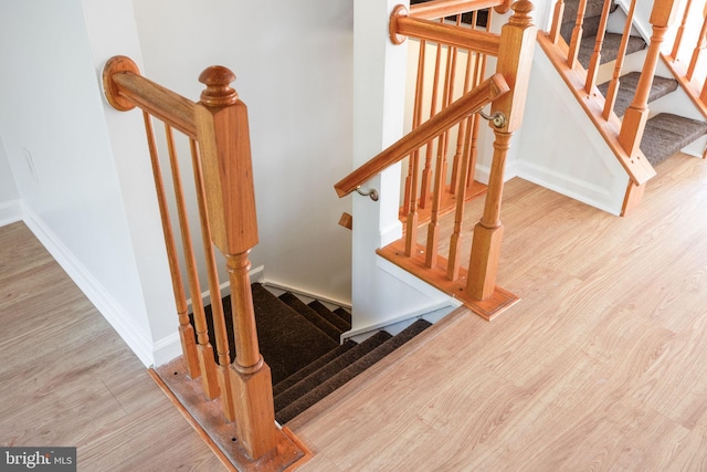 21055 Cornerpost Sq, Ashburn, VA 20147 - staircase with wood finished floors and baseboards