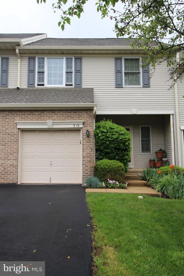 319 Fieldstone Dr, New Hope, PA 18938 - view of front of home with an attached garage, driveway, brick siding, and a front yard