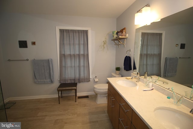 319 Fieldstone Dr, New Hope, PA 18938 - full bathroom featuring double vanity, wood finished floors, toilet, and baseboards