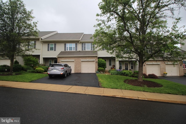 319 Fieldstone Dr, New Hope, PA 18938 - townhome / multi-family property featuring driveway, brick siding, and a front lawn