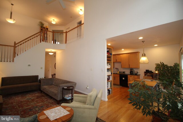 319 Fieldstone Dr, New Hope, PA 18938 - living area with wood finished floors, stairway, a high ceiling, and recessed lighting