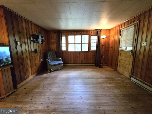 305 Raccoon Dr, Winchester, VA 22602 - unfurnished room featuring wood-type flooring, a baseboard radiator, wooden walls, and baseboard heating