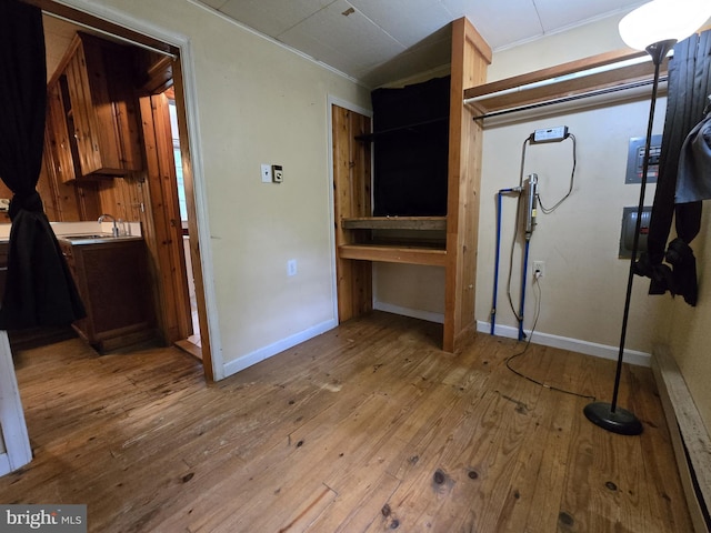305 Raccoon Dr, Winchester, VA 22602 - kitchen with crown molding, wood-type flooring, baseboards, a sink, and light countertops