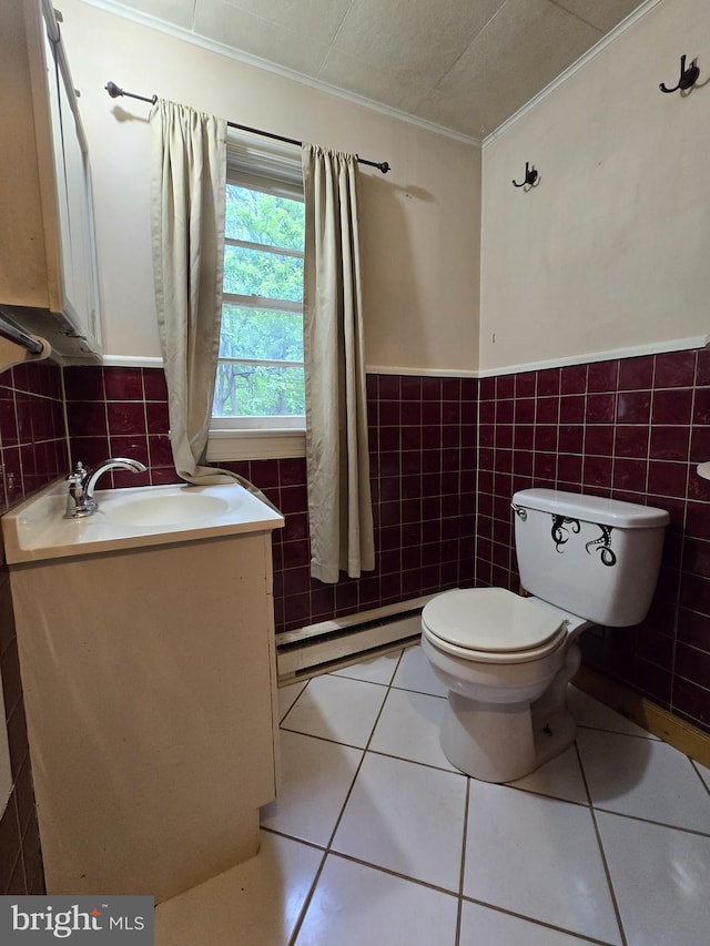 305 Raccoon Dr, Winchester, VA 22602 - half bathroom featuring baseboard heating, crown molding, toilet, vanity, and tile walls