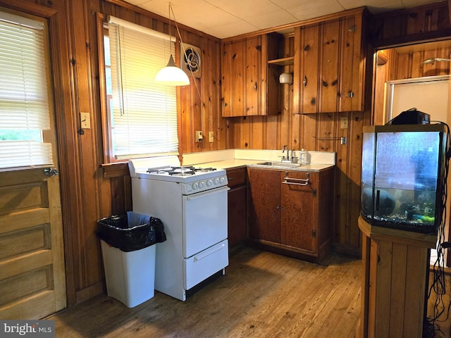 305 Raccoon Dr, Winchester, VA 22602 - kitchen featuring white gas range oven, a sink, wood finished floors, wood walls, and open shelves