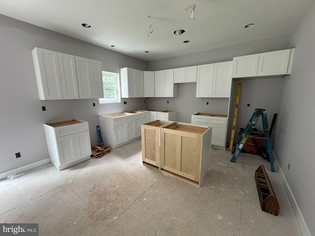 31 N Miller Ave, Carneys Point, NJ 08069 - kitchen with white cabinets, a center island, baseboards, and recessed lighting